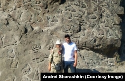 Sharashkin in early July with a man who has carved hundreds of rabbits into a rockface near Petrozavosk.