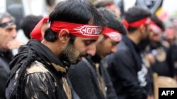 Iranian men cry during the Ashura commemorations that mark the killing of Imam Husayn, one of Shi'ite Islam's most revered figures, in Tehran in 2014.