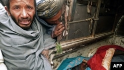 A mourner cries over the bodies of some of the 16 Afghan civilians killed in the massacre on March 11.