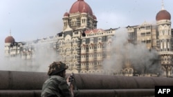 An Indian soldier keeps watch outside the Taj Mahal hotel, the last site held by militants, on November 29