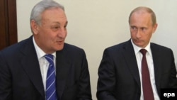 Abkhaz leader Sergei Bagapsh (left, with Russian Prime Minister Vladimir Putin earlier this month) said Abkhaz ships would "destroy" Georgian ships.