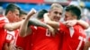 Russia's Yury Gazinsky celebrates with teammates after scoring his side's first goal during the group A match between Russia and Saudi Arabia on June 14 in Moscow. Russia won 5-0.