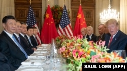 Chinese President Xi Jinping (left) and U.S. President Donald Trump, along with members of their delegations, hold a dinner meeting at the end of the G20 summit in Buenos Aires on December 1.