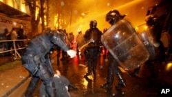 Riot police beat opposition activists at an antipresidential rally in front of the parliament building in Tbilisi on May 26.