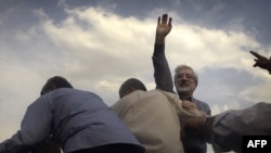 Opposition leader Mir Hossein Musavi waves to supporters during a rally in Tehran just three days after the disputed 2009 vote.