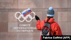 A supporter waves a Russian flag in front the International Olympic Committee headquarters in Switzerland.