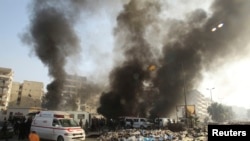 Smoke rises from an Aleppo bus station hit by what activists said was an air stike by forces loyal to Syria's President Bashar al-Assad on January 21.