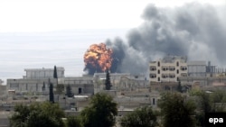 An explosion is seen during fighting in the Syrian border town of Kobani on October 3.