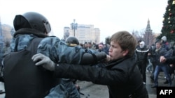 Soccer fans clash with riot police in central Moscow on December 11.