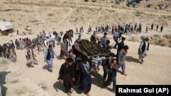 Men carry the coffin of a relative who died in the attack on August 16.