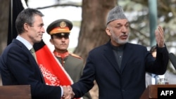 Afghan Preisdent Hamid Karzai (right) gestures as he shakes hands with NATO Secretary-General Anders Fogh Rasmussen in Kabul in mid-October.