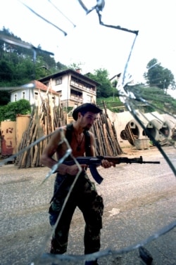 A Serb searching for Muslim fighters inside Srebrenica on July 13.