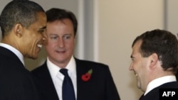 U.S. President Barack Obama (left) greets his Russian counterpart Dmitry Medvedev (right) and British Prime Minister Davis Cameron at the G20 working dinner in Seoul on November 11.