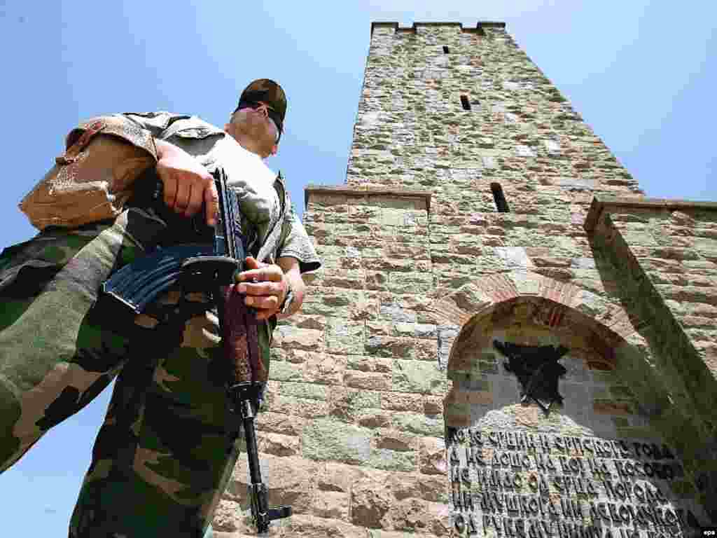 A peacekeeper from the NATO-led force stands guard in front of a monument commemorating the Battle of Kosovo Polje in Gazimestan in 2007.