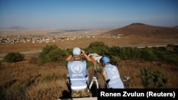 UN peacekeeping troops look over the border line between Syria and the Israeli-occupied Golan Heights.