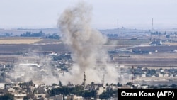 Smoke rises from the Syrian town of Ras al-Ain on October 15.