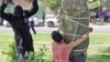 The Amnesty statement included an image used in Iranian news coverage of the incident, showing a young man tied to a tree as he was being flogged by a masked man. The rights watchdog said it could not independently verify whether it was a photo of the actual flogging in question.