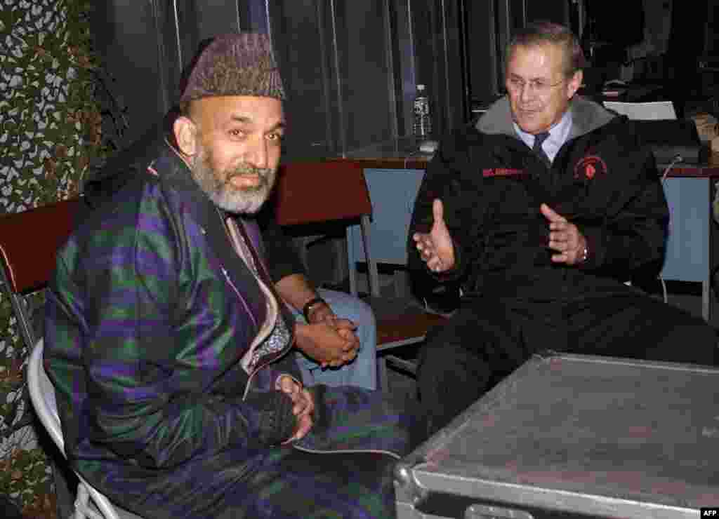 U.S. Defense Secretary Donald Rumsfeld (right) meets with&nbsp;Karzai&nbsp;at Bagram air base outside Kabul&nbsp;on December 16, 2001, six days before Karzai&nbsp;took the&nbsp;oath of office as chairman of the Afghan interim administration.&nbsp;Rumsfeld had&nbsp;arrived at Bagram for&nbsp;a surprise visit, the first by a senior U.S. official to Afghanistan since U.S.-led strikes began against the Taliban&nbsp;in October 2001. 