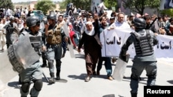 Afghan riot police clashed with demonstrators during an antigovernment protest in Kabul on June 2. At least five people were killed in the violence.