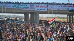 Iraqi protesters pray during a demonstration in Ramadi, capital of the western region of Anbar, on December 28.