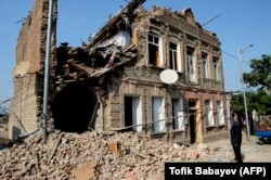 A man looks at a residential building damaged by shelling in the city of Ganca, Azerbaijan's second-largest, on October 27.