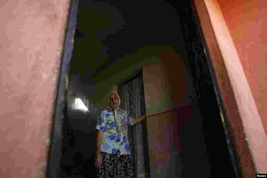 A refugee at the entrance of her home in Bosnia-Herzegovina. Of the 10.4 million refugees for which the UNHCR is responsible, more than 7 million have been refugees for more than five years.