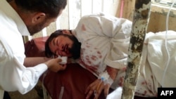 A Pakistani paramedic treats a victim at a hospital in Parachinar, the main town of Kurram tribal district, following twin bomb blasts.