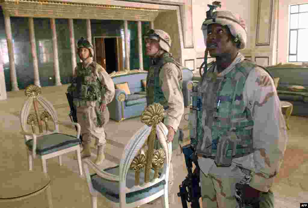 U.S. soldiers observe the reception room of a presidential palace near the international airport southwest of Baghdad.