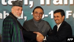 Pakistani President Asif Ali Zardari (center) shakes hands with his Afghan and Iranian counterparts, Hamid Karzai (left) and Mahmud Ahmadinejad, after a joint press conference at the Presidential Palace in Islamabad on February 17.