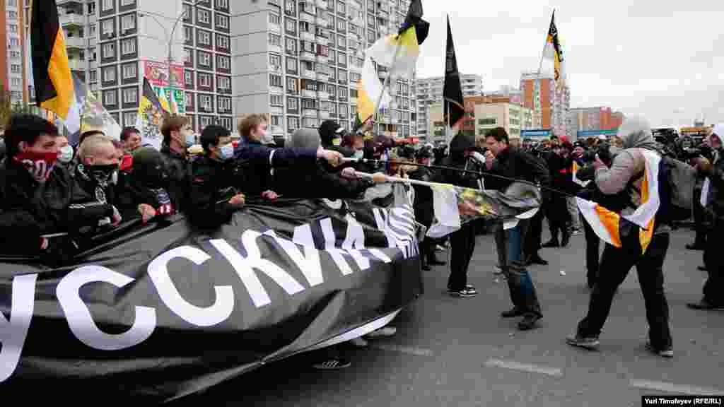 Marchers wave journalists out of the way.