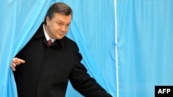 Viktor Yanukovych emerges from a voting booth on February 7.