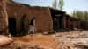 A disabled man walks inside his damaged home after heavy rain in the Zari district of Balkh Province, in northern Afghanistan on March 25.