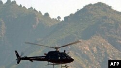 A Pakistani Frontier Corps helicopter flies over monitors the Taliban in the Umar Abad area outside the Buner district. Some 50,000 residents have fled the area due to recent fighting.