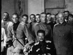 Andrei Shkuro (seated) poses with members of a White Army propaganda organization in 1919.