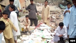 Boys collect books from the rubble of a school allegedly destroyed by Islamic militants in Mingora, the main town in the Swat Valley region.