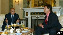 Russian President Vladimir Putin (left) speaks with Paul McCartney during their meeting at the Kremlin in Moscow in 2003.