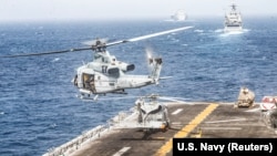 A U.S. Marine helicopter takes off from the flight deck of the U.S. Navy amphibious-assault ship USS Boxer during its transit through the Strait of Hormuz in the Gulf of Oman in July.