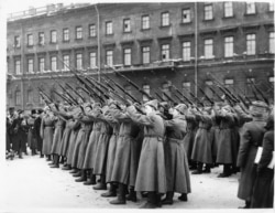 New recruits fire a volley into the air after swearing allegiance to the Red Army.