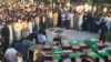 Coffins of those killed in a bomb attack on a Shi'ite mosque in Herat