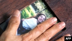 Akiko Saberi, mother of jailed U.S.-Iranian journalist Roxana Saberi, holds a picture of her jailed daughter at the family's house in Tehran.