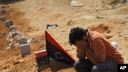 A Libyan man mourns a rebel fighter killed during recent fighting with forces loyal to Muammar Qaddafi near Brega in rebel-held Benghazi on July 17.