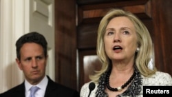 U.S. Secretary of State Hillary Clinton, flanked by Treasury Secretary Timothy Geithner, announced new U.S. steps to increase pressure on Iran in November.