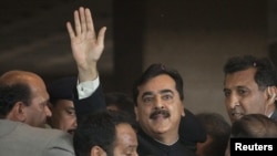 Pakistani Prime Minister Yusuf Raza Gilani waves after arriving at the Supreme Court in Islamabad on April 26.