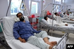 A wounded staff member of Doctors Without Borders receives treatment in Kabul on October 6, 2015.