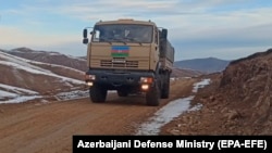 An Azerbaijani military vehicle moves along a road in the Kalbacar region on November 25.