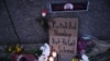 Flowers and signs are left outside the Russian Embassy in Washington on February 16 following the death of Russian opposition leader Aleksei Navalny.