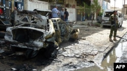 An Iraqi soldier stands guard on May 30 at the site of a bomb blast in Baghdad, which has been plagued by sectarian violence over the past month. 