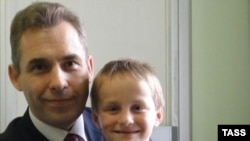 Pavel Astakhov, the Kremlin's ombudsman for children's rights, with Artyom Savelyev, who was adopted by a U.S. woman and sent alone on a flight back to Moscow