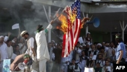 Afghan protesters set fire to a U.S. flag during a demonstration in Kabul on September 21.