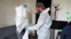 A biocide technician removes pillowcases to prevent the alleged spread of bedbugs in an apartment in L'Hay-les-Roses, near Paris, in September 2023. 